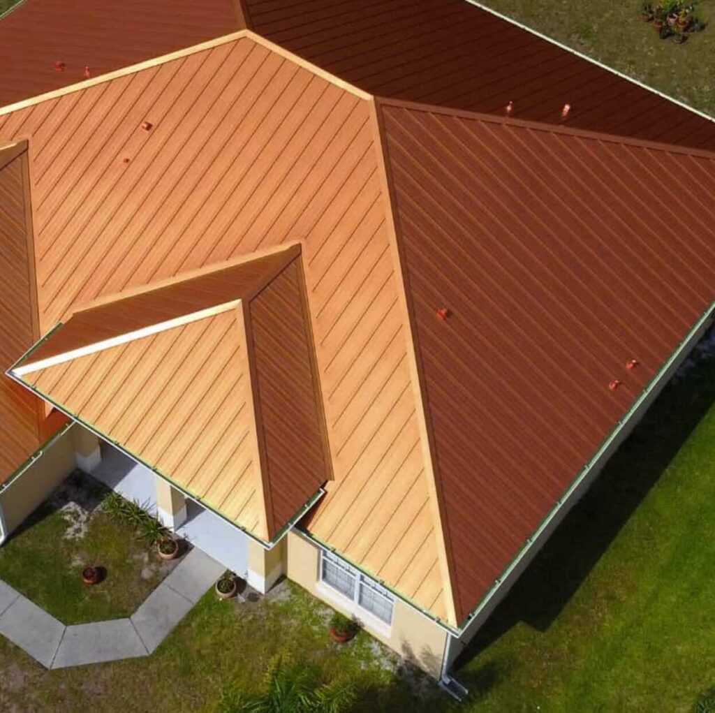 Aerial view of house with brown metal roof.