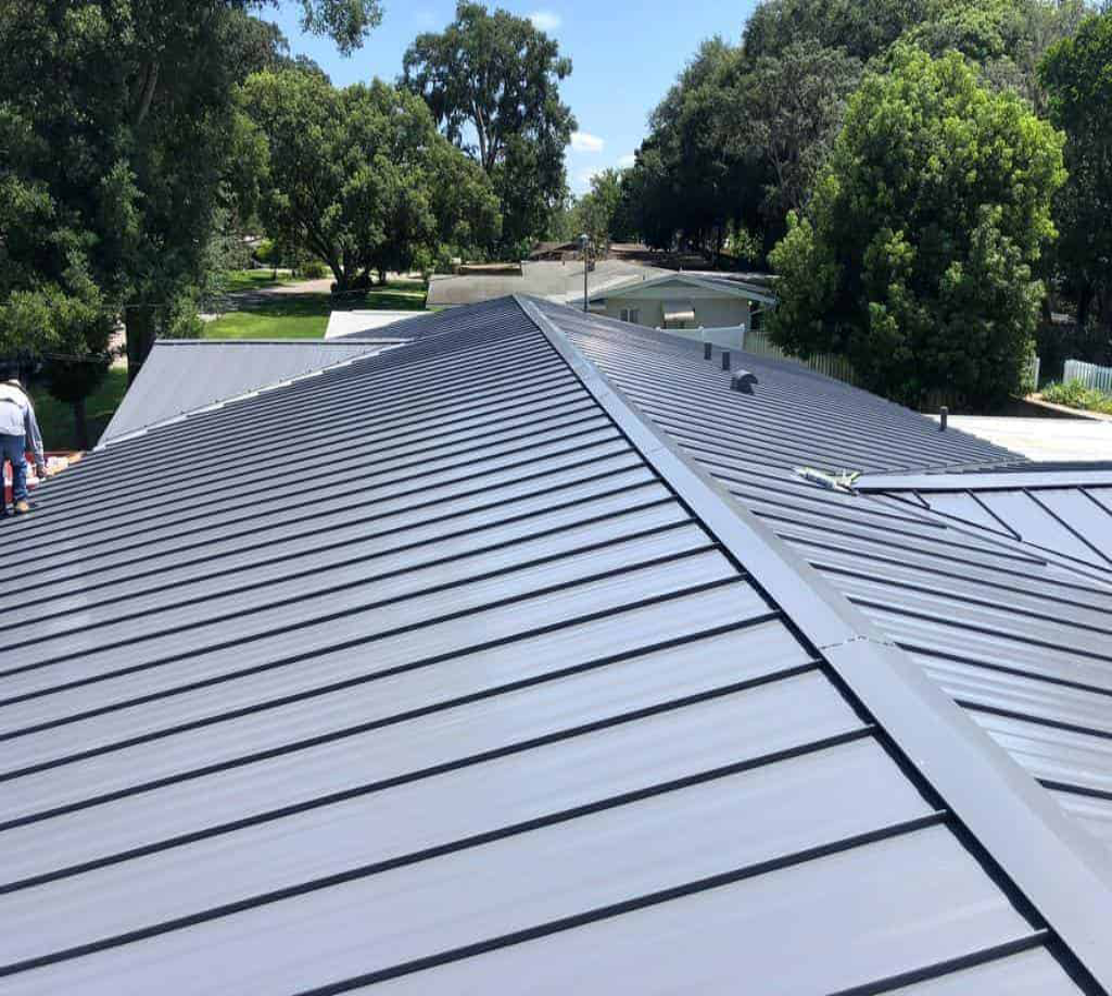 Modern metal roof with green landscape background.