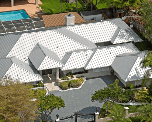 Modern house with metal roof and pool in backyard.