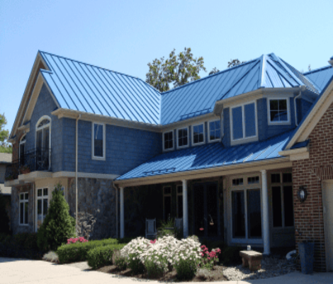 Modern house with blue roof and garden.