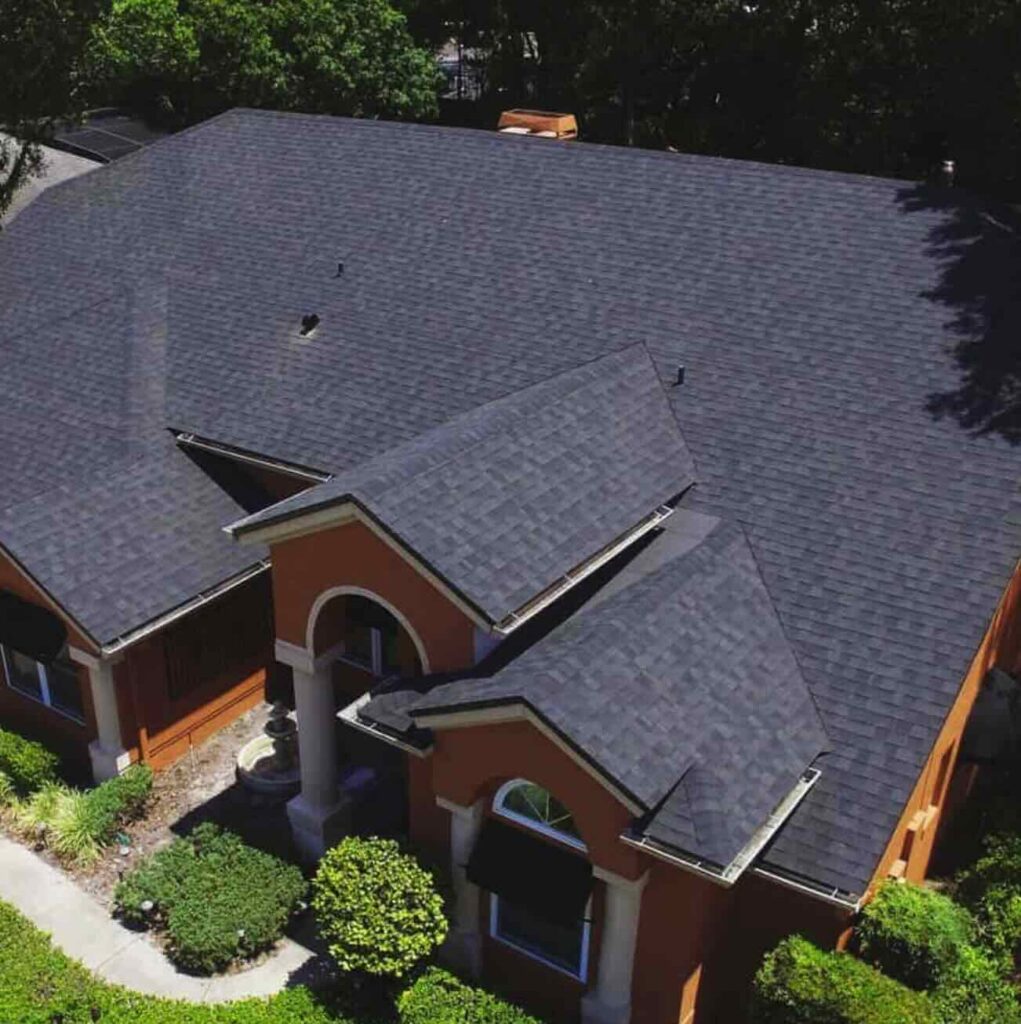 Aerial view of house with gray shingle roof.